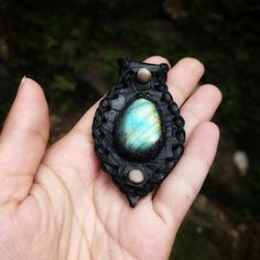 Immerse yourself in the enchanting energies of this Labradorite talisman. Encased in black leather, it radiates a mystical light, offering protection and enhancing your spiritual insight. The talisman comes with an optional leather cord, providing a choice between the natural feel of leather and the pendant alone. Size of the pendant - approx. 3.6cmx7.7cm Uses -Ideal for daily wear to harness the labradorite's intuitive and spiritual energies. -Perfect for meditation or spiritual practices to en Unique Black Leather Jewelry, Handmade Black Leather Jewelry, Artisan Jewelry With Leather Strap For Gift, Black Bohemian Necklace For Everyday Use, Black Bohemian Necklace For Everyday, Black Hand-tooled Bohemian Jewelry, Black Hand Tooled Bohemian Jewelry, Black Bohemian Hand-tooled Jewelry, Unique Black Jewelry For Everyday Use