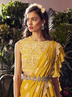 Editor's Note Featuring a yellow paisley print layered ruffle saree paired with an embroidered blouse and embellished belt design with handcrafted kasab work with mirror and swarovski embroider... Ruffle Saree Designs, Basic Blouse Designs, Latest Saree Blouse, Sleeveless Blouse Designs, Drape Sarees, Gota Patti Saree, Happy Dresses, Ruffle Saree, Anita Dongre