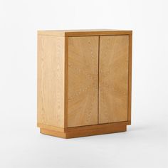 a wooden cabinet sitting on top of a white floor