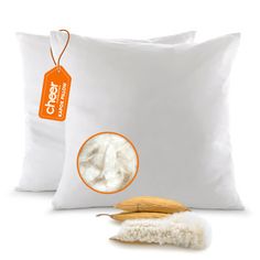 two white pillows and one brown pillow with a tag on the back that says fresh