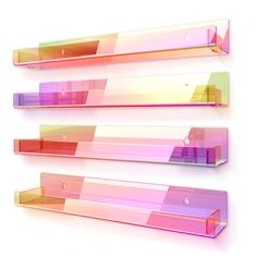 three glass shelves on the wall with different colors and shapes in each shelf, one is empty