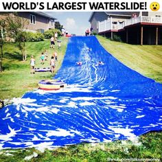 an inflatable water slide is being pulled down the hill