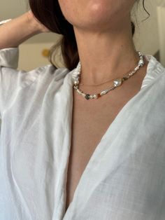 This series of unique necklaces showcases a stunning blend of pearls and gemstones, each one-of-a-kind. With three exquisite pieces in the collection, every necklace boasts a mix of baroque, biwa, keshi, seed, rice, and button pearls, along with accents of kyanite, citrine, labradorite, aquamarine, agate, and black opal. The standout feature is the sailor's wheel clasp, heavy plated in luxurious 14k gold, while all other metal components are crafted from 14/20 K gold filled jeweler's brass for a White Pearl Necklace With Gemstone, Baroque Pearl Jewelry With Round Gemstone Beads, Fusion Style Pearl Chain Jewelry, Baroque Pearl Necklace With Natural Stones As Gift, Baroque Pearl Necklaces With Gemstone Round Beads, Baroque Pearl Necklace With Natural Stones And Round Beads, Baroque Pearl Necklaces With Natural Stones For Gifts, White Baroque Pearl Necklace With Gemstone, Baroque Pearl Necklace With Natural Stones For Gift