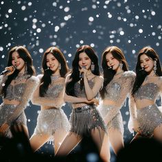 girls'generation performing on stage in the snow with their arms around each other and wearing sequins