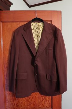 "This retro Dobbshire men's blazer is in gorgeous condition--it comes in a rich chocolate brown color, has a funky yellow lining, and has a crisp 70s collar.  Chest: 42\" Sleeve: 24\" Length: 29\"" Brown Blazer With Welt Pockets And Flat Front, Formal Brown Sport Coat With Lapel Collar, Formal Brown Sport Coat With Hidden Button Closure, Brown Single Button Sport Coat With Suit Collar, Brown Notch Lapel Sport Coat For Semi-formal Occasions, Brown Single Button Sport Coat With Lapel Collar, Brown Single Breasted Sport Coat For Formal Occasions, Brown Semi-formal Blazer With Lapel Collar, Semi-formal Brown Blazer With Lapel Collar