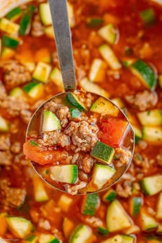 a spoon full of soup with meat and vegetables