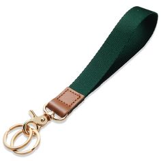 a green and brown lanyard strap with two gold rings on the end, attached to a metal hook