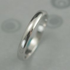 a close up view of a wedding ring on a table with circles in the background