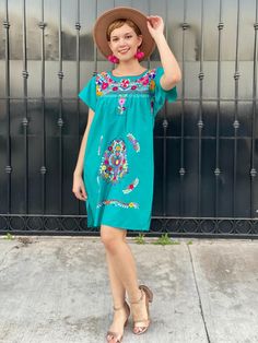 "Mexican embroidered dress women, hand embroidery tunic, cotton short sleeve summer dress, boho hippie sundress, tropical vacation, frida A very bright and fun traditional Mexican dress, short sleeve, teal and multicolor hand embroidered flowers. Great piece to wear in spring, summer, mexican festivities or if you go to a Mexico destination vacay. Loose fit Made of Cotton Fits size SMALL (maybe Medium, check measurements) Measurements taken flat: - Armpit to armpit 21 1/2\" - Bottom hem width 23 Embroidered Short Sleeve Dresses For Summer, Cotton Beach Dress With Embroidered Neckline, Summer Embroidered Mini Dress, Green Boho Dress With Short Sleeves For Vacation, Summer Embroidered Boho Hippie Dress, Embroidered Boho Hippie Dress For Summer, Short Sleeve Dress With Multicolor Embroidery For Summer, Short Sleeve Embroidered Vacation Dress, Multicolor Embroidery Short Sleeve Summer Dress