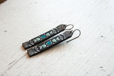 Moon Phases Leather Earrings Long Tooled Turquoise and Black | Etsy Artistic Black Jewelry For Festival, Black Bohemian Hand-tooled Jewelry, Black Hand Tooled Bohemian Jewelry, Black Hand-tooled Bohemian Jewelry, Unique Hand Tooled Black Jewelry, The Moon Phases, Turquoise And Black, Leather Scraps, Light As A Feather