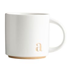 a white coffee mug with the letter f on it's side and a wooden handle