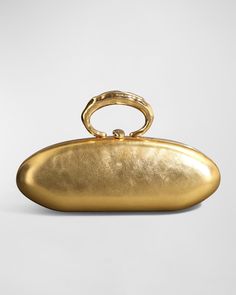 Alexis Bittar "Molton" bullet clutch bag in metallic laminated (high scratch resistance) Italian leather 14-karat gold plated brass ring top handle  Can be worn as a top handle or clutch bag  Framed top with lift-clasp closure  Lining: PU Approx. 4"H x 3.5"W x 3.5"D Item Weight (Lbs.): 1.0 Wipe clean Imported Fancy Clutch Purse, Italian Purses, Metallic Clutch Bag, Vintage Clutch Purse, Gold Bags, Gold Clutch Bag, Molten Gold, Gold Handbag, Gold Evening Bag