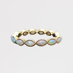 a gold ring with opal stones on it