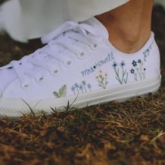 Fresh all white monochrome low top All Star Converse delicately hand embroidered with a meadow of flowers and foliage including daisies, bluebells and ferns. All finished with a name, date, initials or words of your choice. This design can be embroidered in any colour scheme you choose, please leave a note during checkout with any specific requests. Optional extras include embroidery to the heel of the shoe and/or a matching floral posy on the front tongue of the shoes. Each pair is hand made to order and stitched with high quality embroidery thread which is washable and fade resistant.  If you're looking for something a little more bespoke, I offer a limited number of fully custom hand embroidered trainers tailored to your wishes. Consider your wedding theme, your favourite flowers, your Embroidered Trainers, Custom All Star, Meadow Of Flowers, Converse Embroidery, Embroidered Converse, Painted Canvas Shoes, White Canvas Shoes, All Star Converse, Wedding Converse