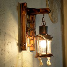 an old fashioned light hanging from a wall