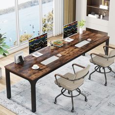 an office desk with two computer monitors and chairs in front of large windows overlooking the water