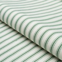 a green and white striped fabric with small lines on the top, as well as two rows