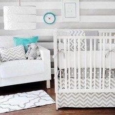 a baby's room is decorated in gray and white