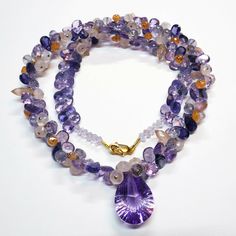 "DESCRIPTION: Thank you for coming in! A breath-takingly beautiful necklace made of an assortment of natural gemstones! You can find Iolite, Amethyst, sunstone and peach moonstone in this one necklace! Premium quality gemstones finished with gold filled headpins and 18k solid yellow gold clasp! 17\" gorgeous necklace, 186.9 carats! You'll get the necklace you see! SIZE: 14.7mmx23.5mm center stone. GRADE: Transparent COLOR: Multi" Amethyst Briolette Necklace With Gemstone Accents, Briolette Amethyst Natural Stone Gemstones, Amethyst Multi-stone Briolette Gemstones, Amethyst Briolette Multi-stone Gemstones, Luxury Amethyst Gemstones With Natural Stones, Luxury Amethyst Multi-stone Necklace, Luxury Multi-stone Amethyst Necklace, Purple Briolette Crystal Gemstone Necklace, Purple Briolette Gemstone Crystal Necklace