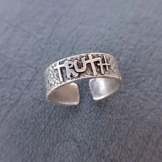 Sure, here's a possible high-ranking description for a Truth Adjustable Gothic Silver Ring: Looking for a striking piece of jewelry that combines elegance with a touch of edginess? Look no further than our Truth Adjustable Gothic Silver Ring! Crafted from high-quality silver and featuring intricate gothic-inspired detailing, this ring is sure to turn heads and make a statement. Plus, its adjustable design ensures a perfect fit for any finger. Whether you're dressing up for a special occasion or Adjustable Spiritual Rings, Symbolic Adjustable Promise Jewelry, Nickel-free Spiritual Jewelry For Promise, Adjustable Symbolic Hypoallergenic Rings, Adjustable Celestial Engraved Jewelry, Nickel Free Symbolic Open Ring Jewelry, Spiritual Nickel-free Open Ring Jewelry, Nickel-free Symbolic Open Ring Jewelry, Symbolic Nickel-free Open Ring Jewelry