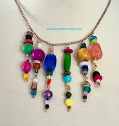 Elevate your jewelry game with this colorful multi-beaded charm necklace. This stunning piece features a unique blend of multi-colored beads in a variety of shapes and sizes. At 20 inches in length, it is a versatile addition to your wardrobe that can be worn all year round. Not only will it add a pop of color to any outfit, but it also showcases your trendsetting and outgoing style. You don't have to break the bank to own this handmade necklace, making it perfect for those looking for affordabl Cheap Trendy Multi-strand Charm Necklaces, Multicolor Beaded Necklaces With Dangling Beads, Multicolor Dangling Beaded Necklace, Rainbow Necklaces With Spacer Beads For Jewelry Making, Vibrant Multicolor Beaded Necklaces With Large Beads, Multicolor Dangle Necklaces With Colorful Beads, Multicolor Dangle Necklace With Colorful Beads, Bohemian Rainbow Beaded Necklaces With Wooden Beads, Bohemian Rainbow Beaded Necklace With Wooden Beads