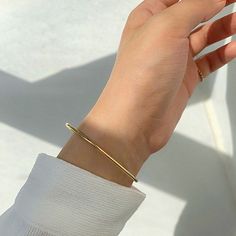 Say "hello" to timeless elegance with these stackable 18K Gold Plated Stainless Steel Bangles. Crafted from quality stainless steel and with its beautiful minimalist design, these lovely bracelets are both chic and durable, perfect for your next night out. The tarnish-free finish ensures they'll keep their shine for years to come. Add a touch of luxury to your look with these classic pieces! Classic Everyday Bangle, Tarnish Resistant, Classic Everyday Tarnish-resistant Bangle, Dainty Everyday Cuff Bangle Bracelet, Dainty Bangle Cuff Bracelet For Everyday, Dainty Everyday Cuff Bangle, Simple Bangle Jewelry For Everyday Use, Elegant Everyday Cuff Bracelet, Trendy Tarnish Resistant Bangle For Everyday, Classic Everyday Metal Bangle