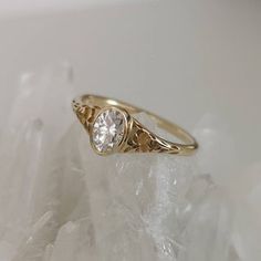 a gold ring with a white diamond on it