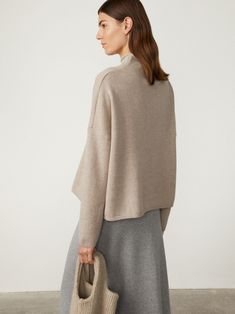 A plush top layer, the Sandy sweater is crafted in rich, heavy knit cashmere to wide proportions. The enveloping silhouette creates effortless drapes at the front and back, made sublime by the generous rolled mock neck and relaxed dropped shoulders. High Neck Cashmere Sweater For Fall, Cashmere High-neck Turtleneck For Fall, Fall Cashmere High Neck Turtleneck, Fall Cashmere Turtleneck, Cashmere Funnel Neck Sweater For Work, Casual Cashmere Sweater With Funnel Neck, Funnel Neck Cashmere Sweater For Work, Cashmere Turtleneck For Fall, Merino Wool Funnel Neck Sweater For Fall