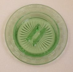 a green glass bowl sitting on top of a counter