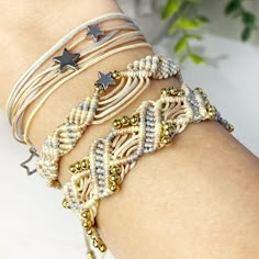 a woman's arm with bracelets and stars on the wrist, both decorated with beads