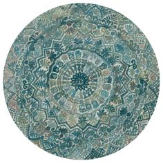 a round rug with an intricate design on the center and sides, in green tones