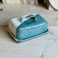 a blue and white dish sitting on top of a wooden table