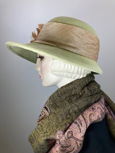 This hat would be right at home on Downton Abbey! The color is a really pretty pistachio green. It is topped with a light tan silk band that coordinates perfectly! Embellished with three vintage silk and velvet flowers. The brim shape is a soft oval and the sides are longer than the front; the back is much narrower at 2 1/4 inches. It is hand blocked using traditional millinery techniques, including steaming, shaping, and hand sewing. ++++++++++++++++++++++++++++++++++++++++++++++++++++++FIT AND Kentucky Derby Fur Felt Cloche Hat With Flat Brim, Cream Short Brim Felt Hat For Kentucky Derby, Fur Felt Boater Hat For Kentucky Derby, Kentucky Derby Fur Felt Cloche Hat With Short Brim, Wool Hats For Kentucky Derby, Fur Felt Cloche Hat For Kentucky Derby, Fitted Brimmed Gatsby Hats, Fitted Beige Brimmed Felt Hat, Vintage Style Fitted Beige Fedora