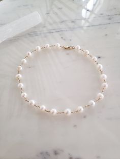 This handmade necklace is perfectly on trend and yet completely timeless and classic. Genuine freshwater pearls are hand wrapped with top quality materials. 925 sterling silver or 14k gold fill. These pearls are imperfectly round, so charming and natural. Hypoallergenic, lead and nickel free. Excellent for sensitive skin! Comes packaged in a gift box. ~M A T E R I A L S ~ Choose from- * 925 Sterling silver *14k Gold fill *14k Rose gold fill **What is 14k Gold-fill?** Gold fill does not tarnish o White Single Strand Pearl Necklace With 14k Gold Filled, Minimalist Single Strand Akoya Pearl Necklace, Dainty Single Strand Akoya Pearl Necklace, Dainty Akoya Pearl Single Strand Necklace, White Single Strand Pearl Necklace In 14k Gold, Elegant 14k Gold Filled Choker Gift, White Pearl Chain Necklace In 14k Gold Filled, White Pearl Chain Necklace In 14k Gold, Elegant 14k Gold Filled Choker Jewelry