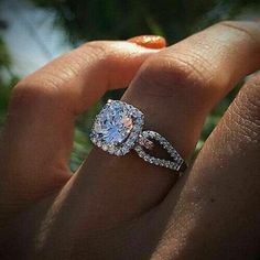 a woman's hand with a ring on it and an engagement band around her finger