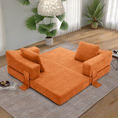 an orange couch sitting on top of a rug in a living room