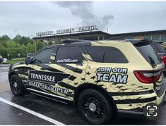 a yellow and black truck parked in front of a building with the words join our team painted on it