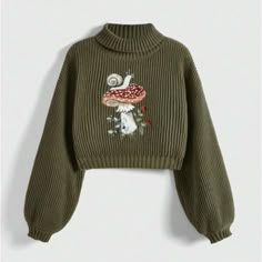 Featuring Intricate Mushroom Embroidery And Rib-Knit Details, This Cozy Pullover Exudes A Whimsical Yet Casual Vibe. The Stand Collar And Long Lantern Sleeves With Drop Shoulders Create A Relaxed, Oversized Fit, Perfect For Layering Or Wearing On Its Own. With A Medium Stretch Fabric, This Sweater Offers Both Comfort And Style. The Regular Length And Loose Fit Provide A Laid-Back Silhouette That Pairs Effortlessly With Any Casual Look, Making It An Ideal Addition To Your Autumn And Winter Wardro Cute Sweaters Aesthetic, Sweater Types, Clothes Mushroom, Plant Clothes, Sweater Patches, Fairycore Mushroom, Mushroom Clothes, Mushroom Sweater, Mushroom Embroidery