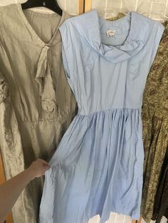 Lot of 4 1950’s dresses1. Light blue cotton dress, has underarm discoloration. Bust 39” waist 27” hips free2. Green paisley, major sun fading, see photos. 42” bust 28” waist hips free3. Grey linen dress, small stains throughout. 50” bust 40” waist 48” hips4. Green and brown cotton paisley striped dress. Missing all but two buttons. Bust 36” waist 25” hips free.All being sold as is, will need repairs Light Blue Retro Summer Dress, Retro Light Blue Summer Dress, 1950s Style Blue Summer Dress, 1950s Style Short Sleeve Summer Dress, Light Blue Vintage Cotton Dress, Blue 1950s Style Summer Dress, 1950s Blue Summer Dress, Vintage Light Blue Cotton Dress, Vintage Light Blue Knee-length Dress