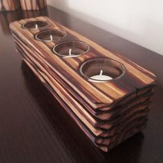 a stack of wooden candles sitting on top of a table