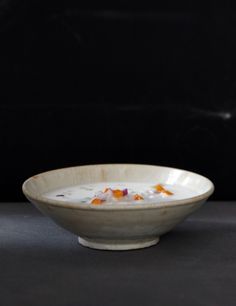 a white bowl filled with soup on top of a table