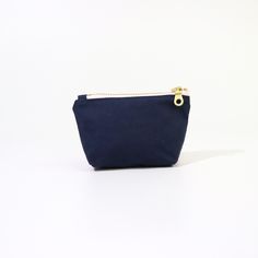 Introducing the Geometric Poofy Coin Pouch: a delightful blend of charm and versatility. This unique pouch combines a playful pink geometric pattern on one side with durable navy dry oilskin on the other, offering a stylish contrast that stands out. Measuring approximately 3.5" x 5" with a poofy, 1" gusseted design, this pouch not only holds your coins and small essentials but also stands on its own for easy access. The brass-colored metal zipper ensures secure closure, while adding a touch of vintage elegance to its modern design. Whether slipped into a purse or carried solo, the Geometric Poofy Coin Pouch is perfect for adding a pop of color and personality to your everyday carry. It's an ideal accessory for those who appreciate practicality without compromising on style. Minimalist Rectangular Everyday Coin Purse, Modern Pouch With Zipper Pocket For Personal Use, Practical Pouch Pencil Case For Everyday Use, Minimalist Everyday Rectangular Coin Purse, Minimalist Rectangular Coin Purse As Gift, Minimalist Rectangular Coin Purse For Gift, Modern Rectangular Coin Purse For Everyday Use, Modern Coin Purse With Zipper Pocket For Daily Use, Modern Coin Purse For Daily Use