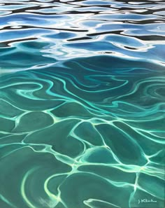 a person is holding a pen and writing on the surface of an ocean with blue water