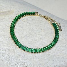 "Sparkling. Finished in 18k gold, this tennis bracelet boasts full pavé emerald crystal bands that will add a shimmering touch to your days.  Details: 6.9\" Length + 1.8\" extension 0.3 oz 18K Gold-Plated Tarnish-Free  Hypoallergenic and Nickel-Free" Green Cubic Zirconia Crystal Bracelet, Gold Emerald Tennis Bracelet As A Gift, Emerald Tennis Bracelet, Emerald Crystal, Wedding Bracelets, Bracelet Tennis, Wedding Jewelry Bracelets, Wedding Bracelet, Tennis Bracelet