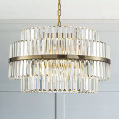 a chandelier hanging from the ceiling in a room with white walls and flooring