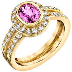 This pretty ring features a vibrant pink sapphire and sparkling diamonds in an 18k yellow gold setting that is perfect for everyday wear! The pink sapphire has been bezel set and framed with a halo of white diamonds, with two rows of additional diamonds continuing down the split band for double the luxurious effect! This elegant ring can be worn day and night, on either hand! Pink sapphire, 5.50 x 7.00mm, 1.14 carats 36 round brilliant cut diamonds, .57 carat total Ring size 6.5 Complimentary si Pretty Ring, Bezel Set Ring, Diamond Halo Engagement Ring, Gold Ring Designs, Yellow Gold Setting, 18k Yellow Gold Ring, Halo Diamond Engagement Ring, Pretty Rings, Elegant Ring