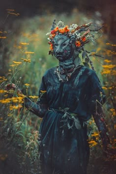 a woman with flowers in her hair standing in a field full of wildflowers