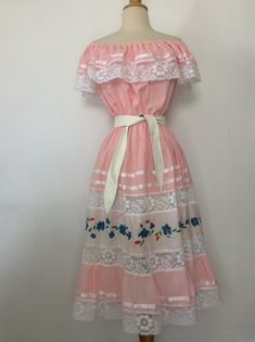 "Vintage Dress 1970's Vintage Oaxacan Mexican Wedding Dress Pink Cotton or Cotton Blend. No tags Elastic Top, so can be worn Off or On Shoulder 6\" Ruffle with White Lace and Ribbon Trim Elastic Waist The Skirt has 2 Sheer Lace Inserts with an Embroidered Panel in between I have it shown with and without a belt. Belt Not Included. No size tag, so Please go by measurements taken laid flat seam to seam 20-23\" armpit to armpit 10-21\" waist 26\" hips 35\" long from armpit Excellent Vintage Conditi 1970s Mexican Fashion, Mexican Pink Dress, Mexican Dress Aesthetic, 1960s Mexican Fashion, Pink Mexican Outfit, Traditional Mexican Dress For Women, Guatemalan Dresses, Vintage Mexican Fashion, Pink Mexican Dress