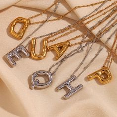 Add some playful personalization to your summer wardrobe with our Bubble Letter Necklace! This quirky accessory is a perfect gift for her, adding a fun touch to any outfit. Layer it up for a fun #neckmess! DETAILS & SIZE Finish: 18K gold plate Materials: 316L Stainless Steel Measurements: Pendant: 19.4x14.4mm; Chain: 16" + 2" extension Lobster claw clasp Waterproof, tarnish-resistant, and nickel free. Shop Necklaces for more options! Bubble Letter Necklace, Balloon Letters, Gold Initial Necklace, Bubble Letter, Letter Pendant Necklace, Bubble Letters, Initial Necklace Gold, Letter Balloons, Waterproof Jewelry