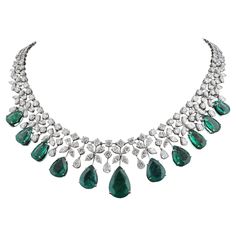 The necklace is meticulously crafted from 18 karat white gold, chosen for its luxurious appearance and durability. The white gold setting perfectly complements the emerald and diamonds, creating a harmonious fusion of elegance and strength. The intricate detailing and craftsmanship are evident in every aspect of the necklace, showcasing the artisan's skill and expertise. Item Code :- CN-24662 Gross Wt. :- 61 gm 18k Solid White Gold Wt. :- 48.18 gm Natural Diamond Wt. :- 24.3 Ct. ( AVERAGE DIAMON Formal White Gold Emerald Necklace With Jewels, Luxury Diamond Bridal Necklace With Gemstone, Luxury Bridal Necklace With Diamond Gemstone, Elegant White Gold Emerald Necklace With Jewels, Elegant White Gold Emerald Necklace, White Gold Diamond Necklace With Jewels, Formal Emerald Diamond Necklace In White Gold, Luxury White Gold Emerald Diamond Necklace, Formal White Gold Emerald Diamond Necklace